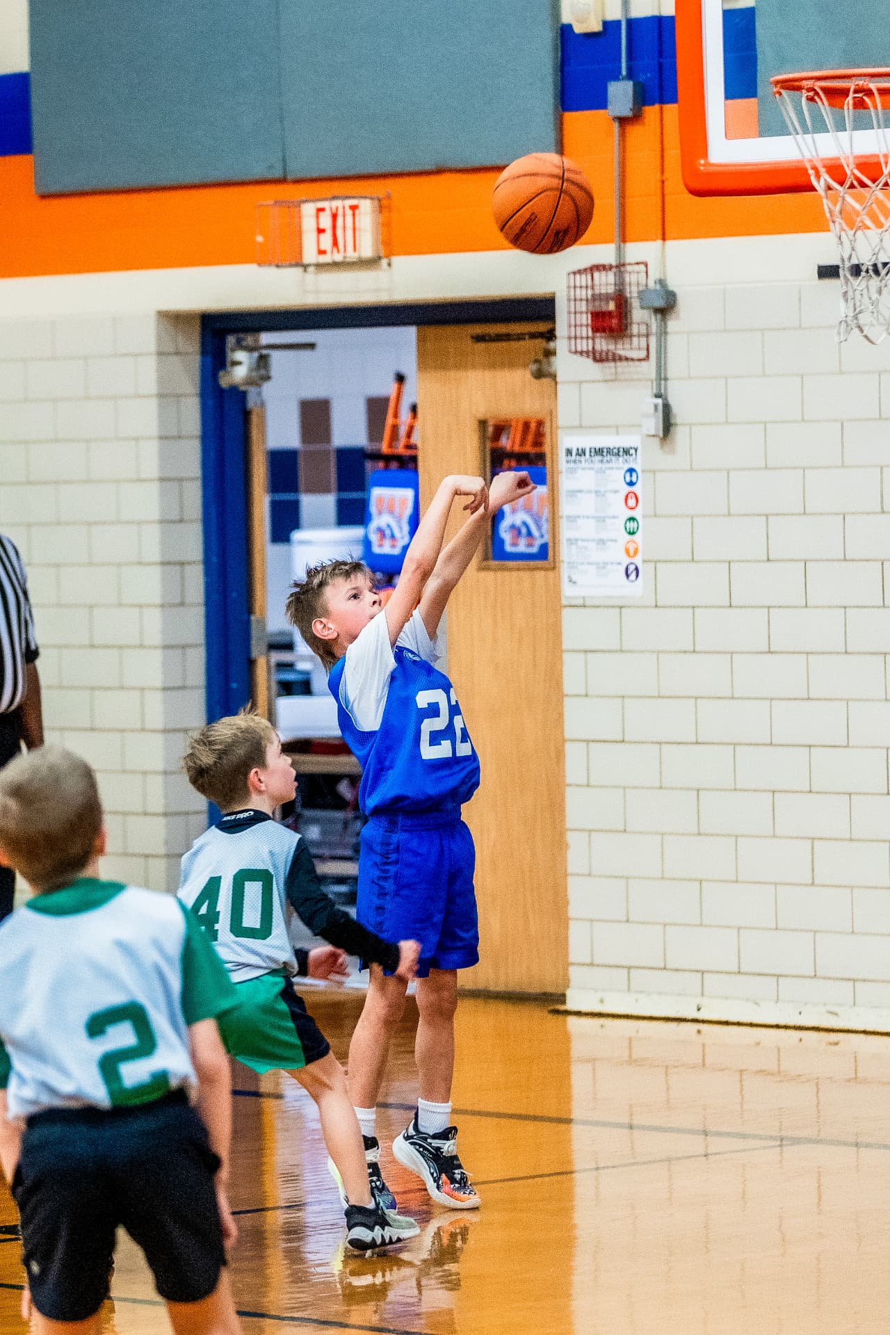 Young basketball player following through on a jump shot