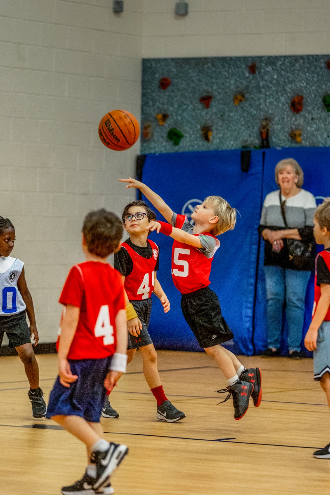 Young player shooting during a kindergarten basketball game