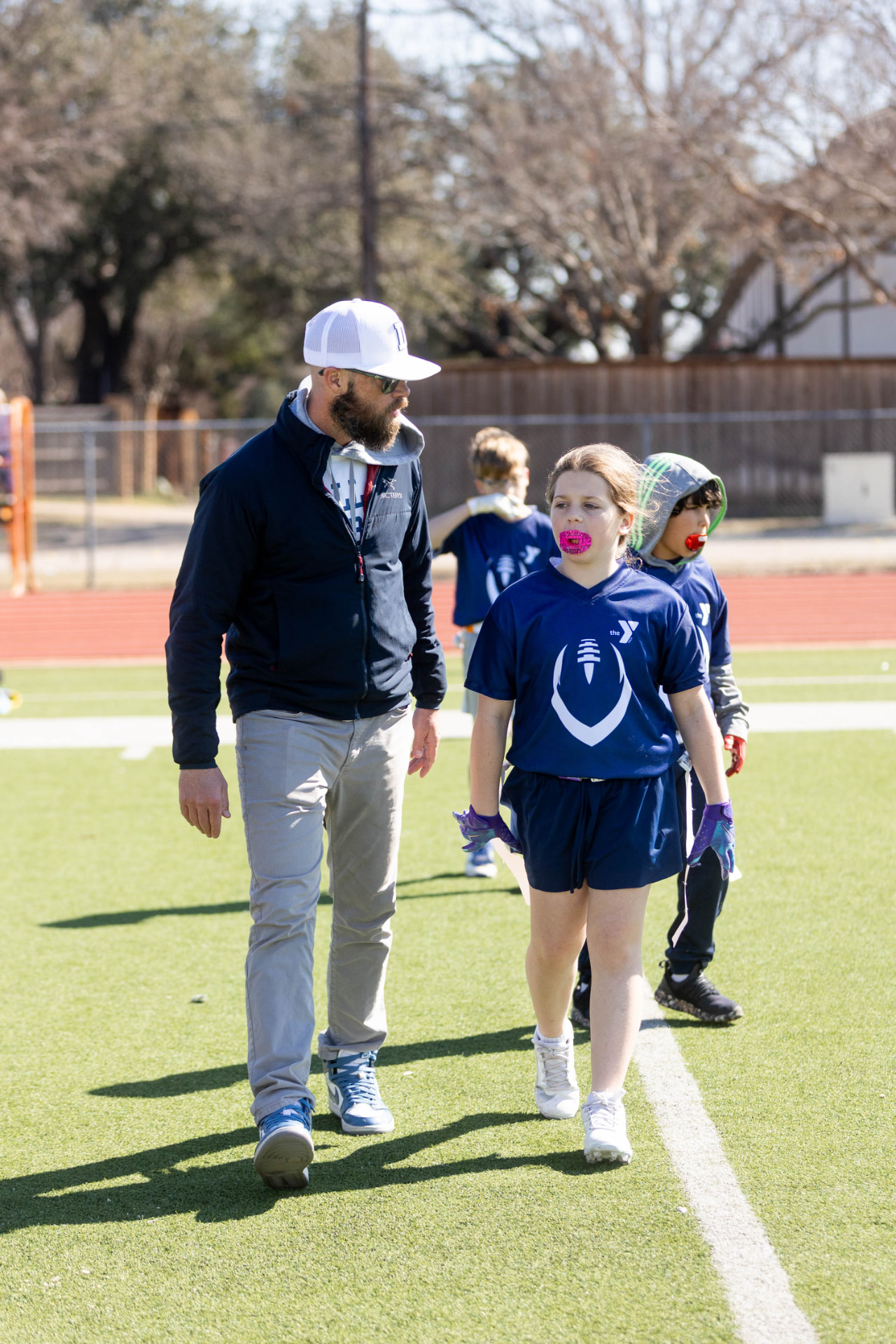Coach talking with young players on the field