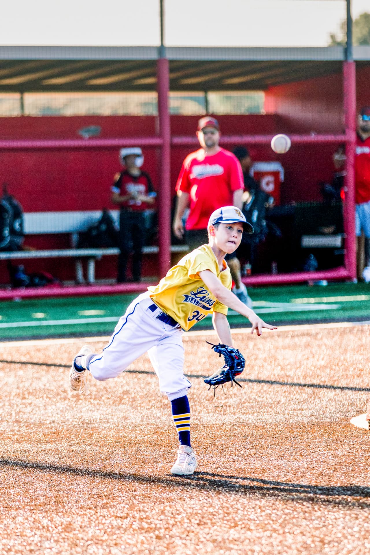 Youth baseball pitcher delivering a pitch
