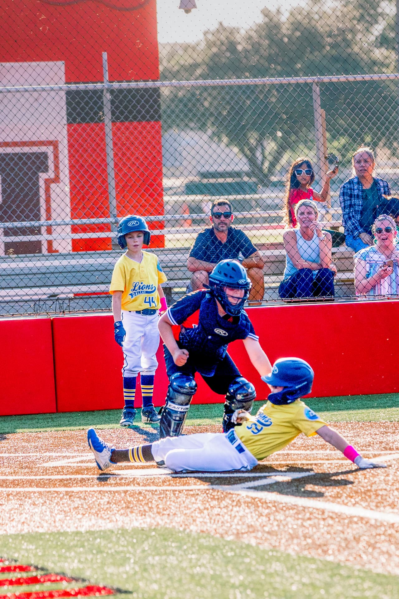 Baseball player sliding into home plate