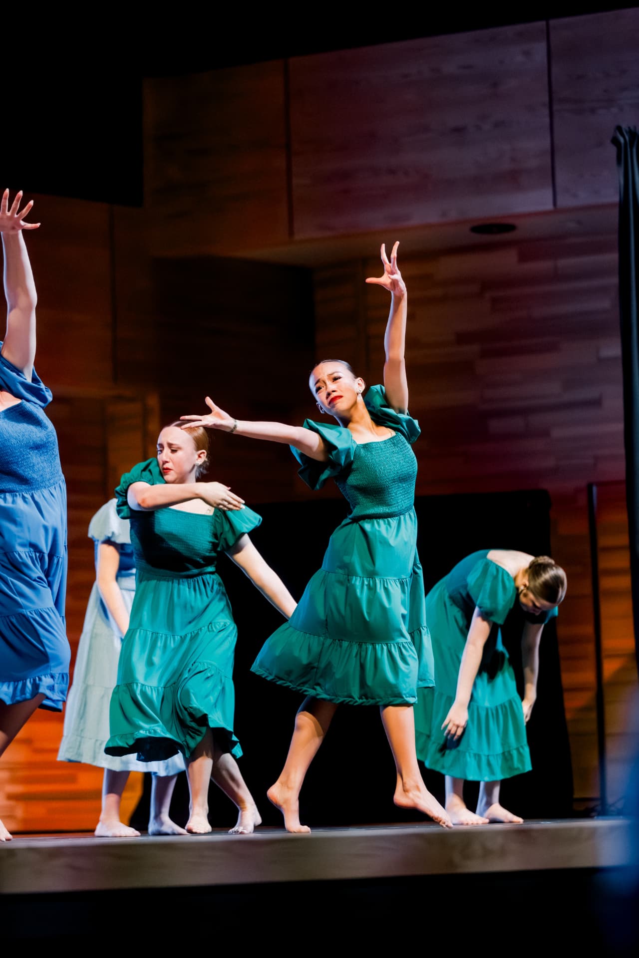 Group of dancers in green dresses performing