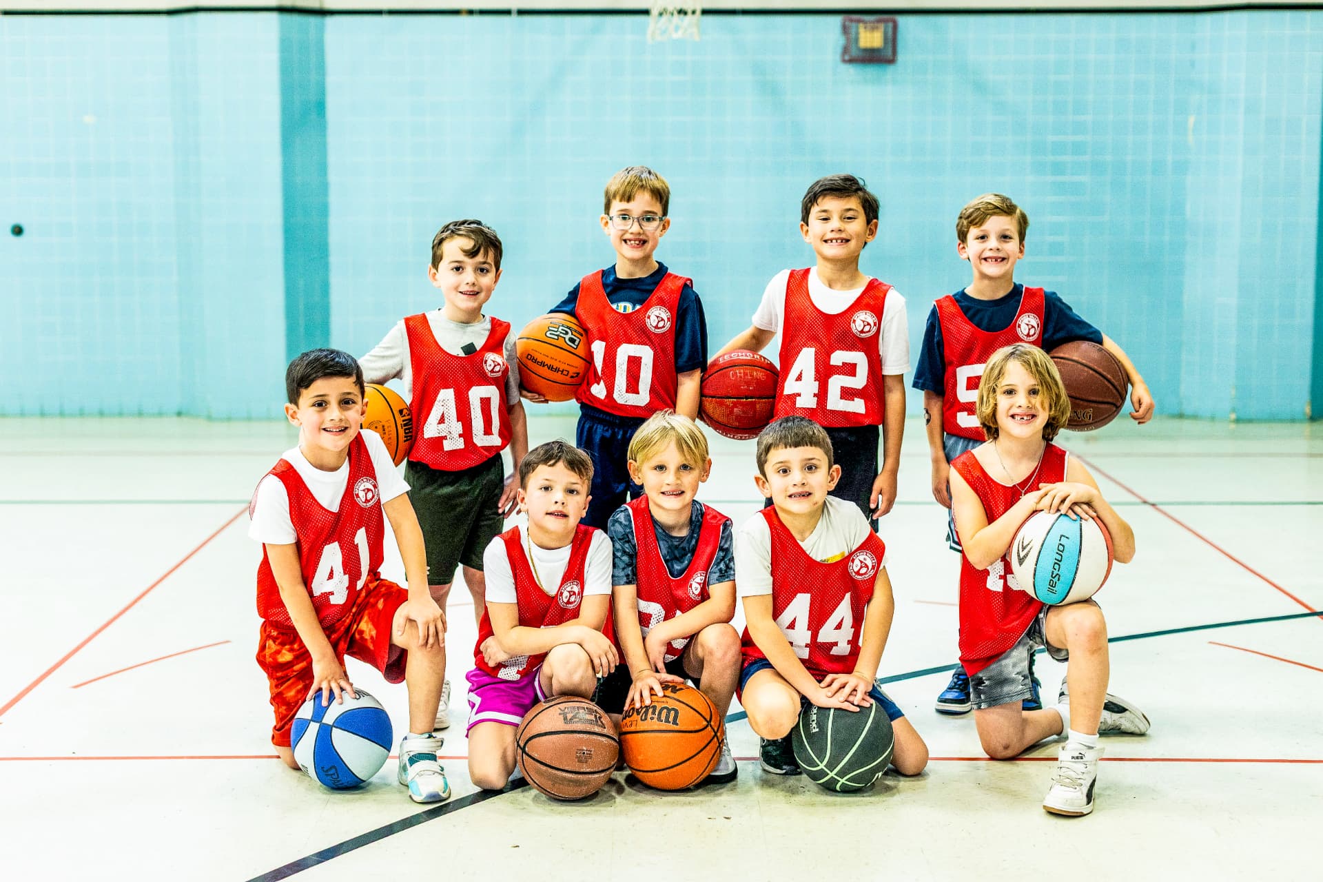 Youth basketball team group portrait with basketballs