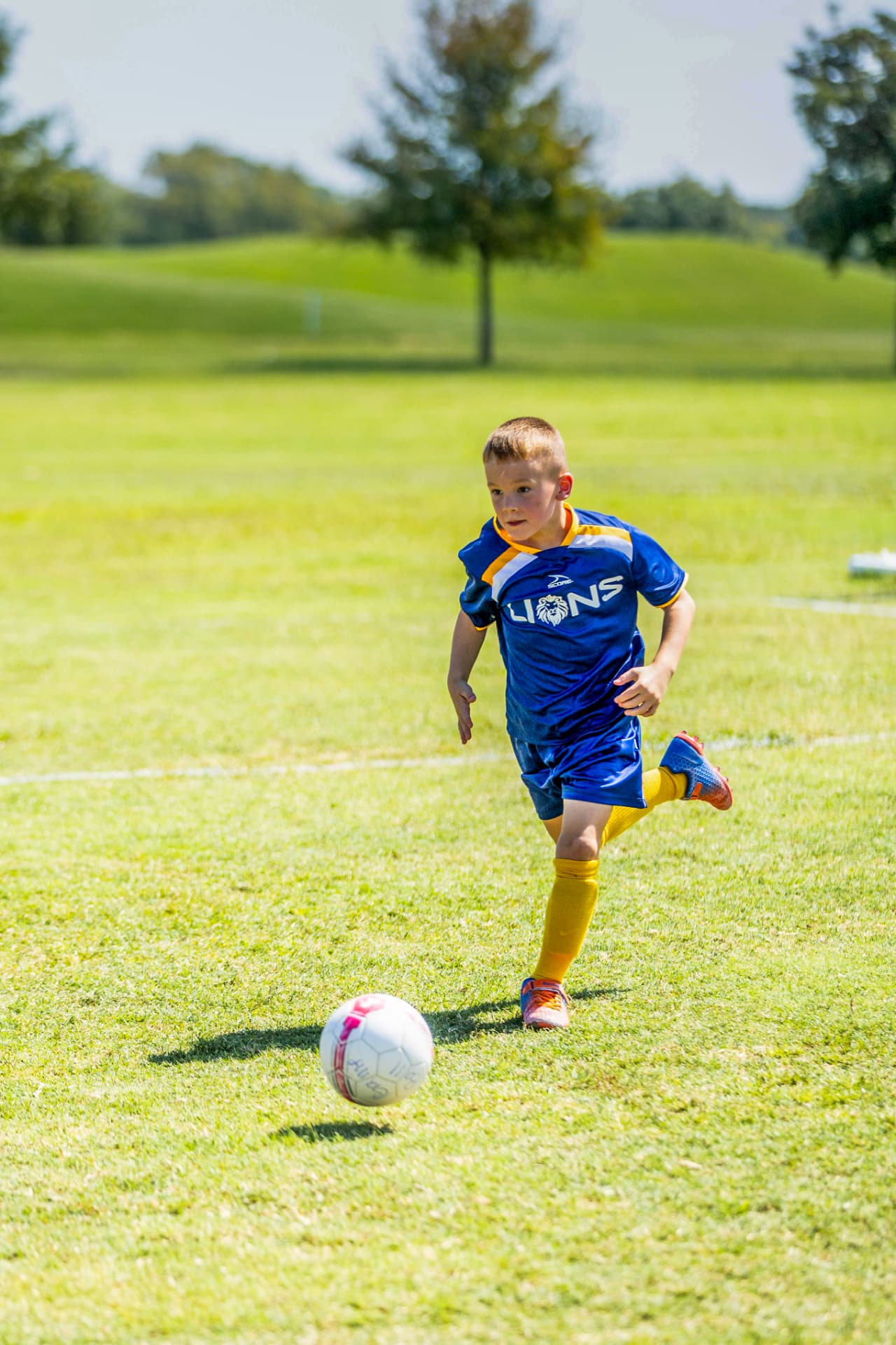 Young soccer player chasing the ball