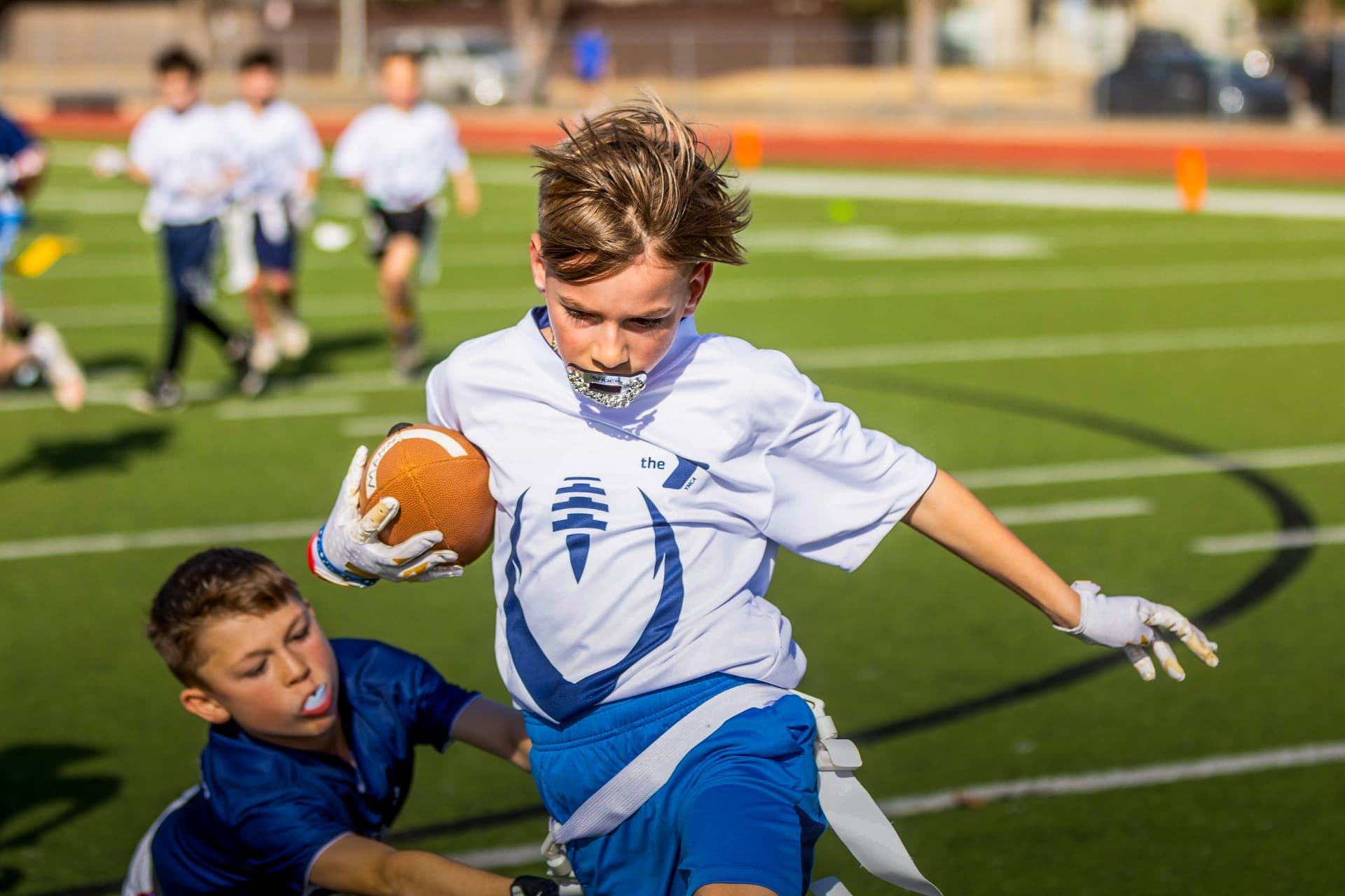 Flag football runner breaking a tackle