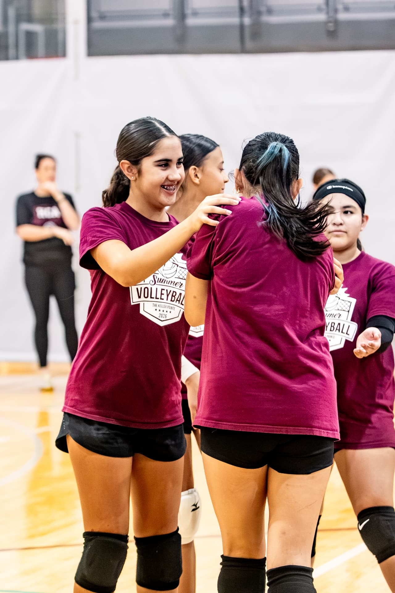 Volleyball teammates celebrating a point