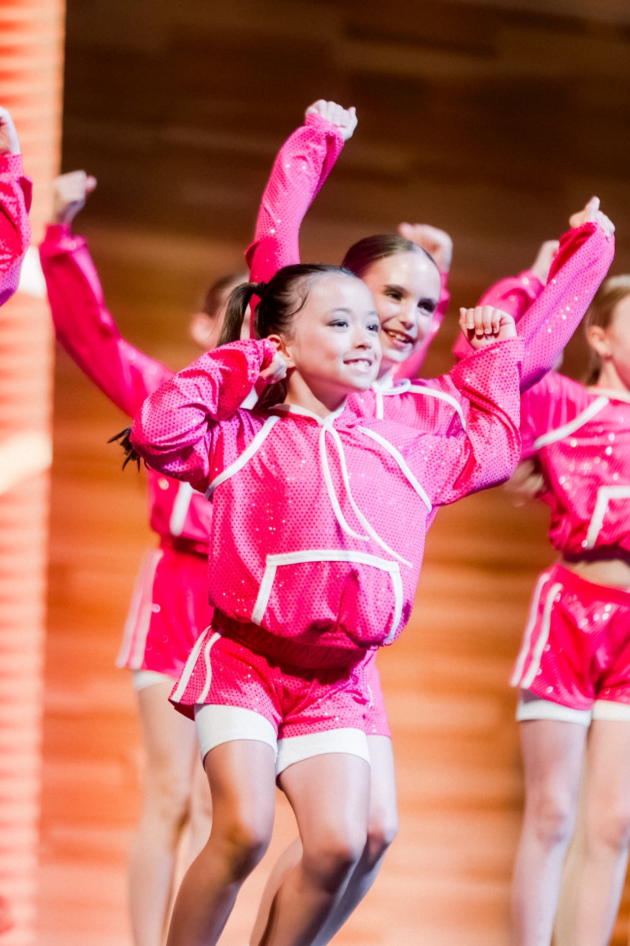 Young dancers in pink costumes performing