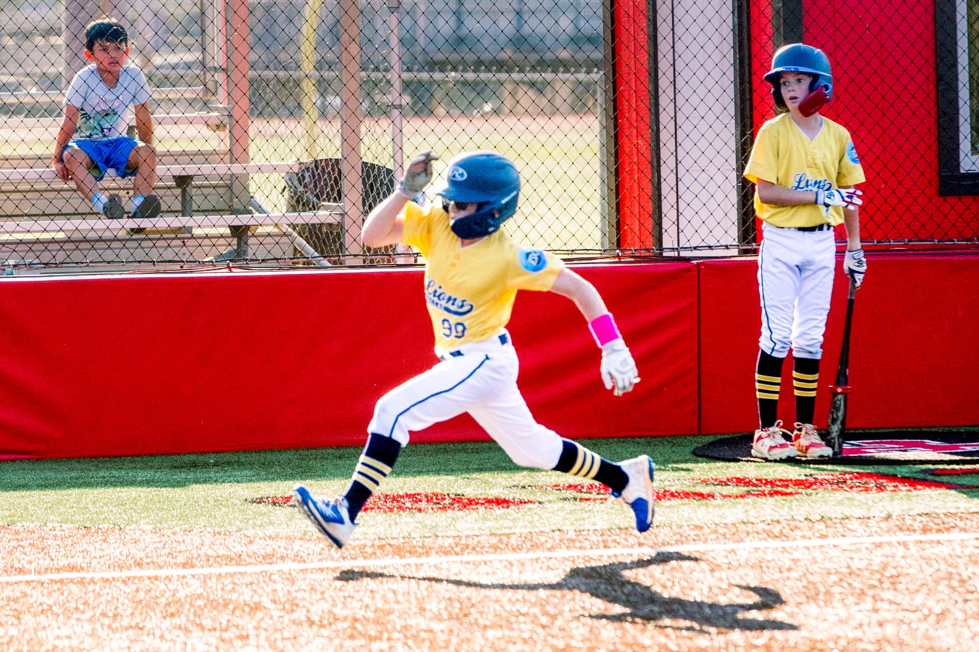 Youth baseball player swinging at a pitch