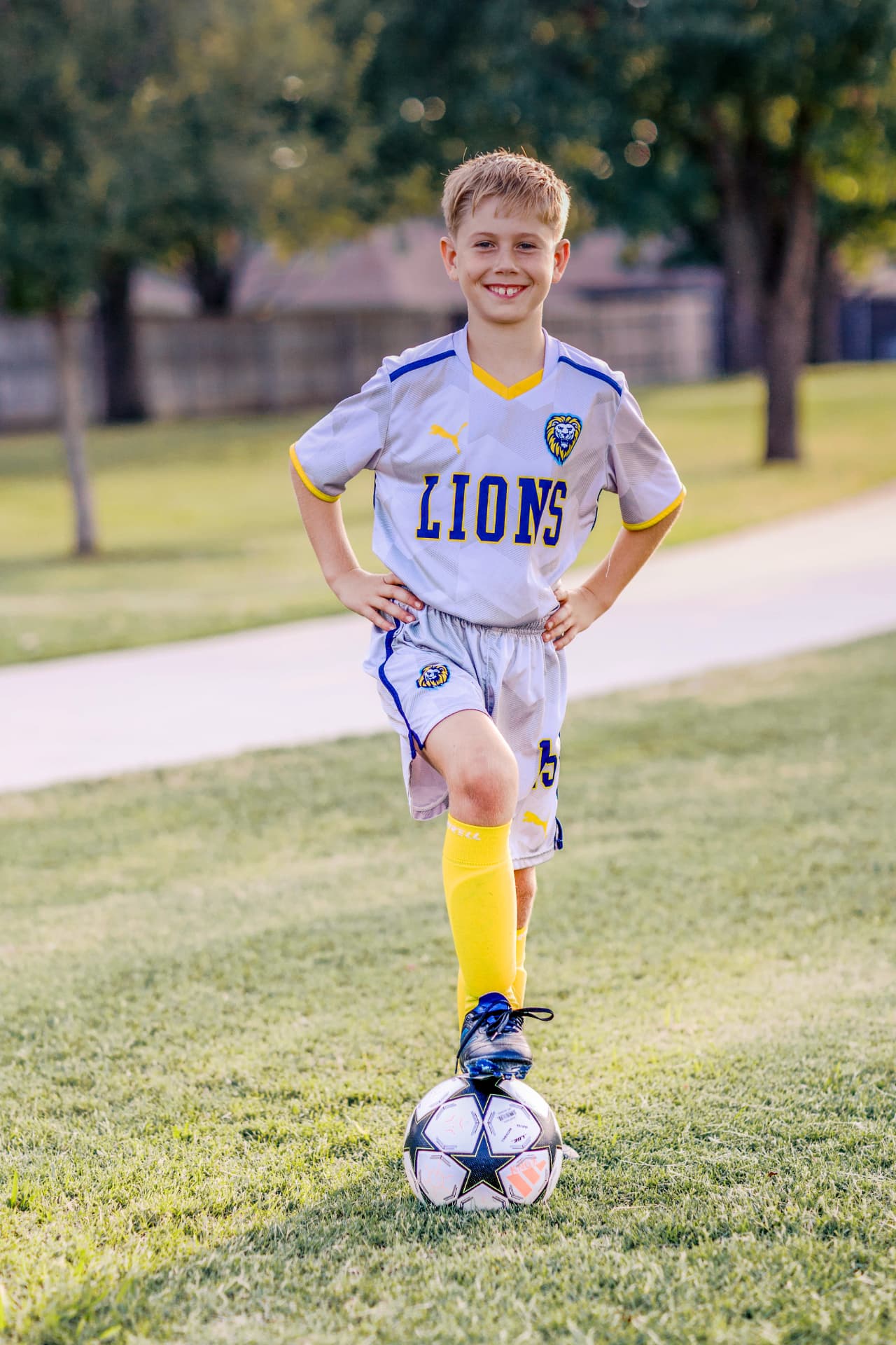 Youth soccer player posing with a ball