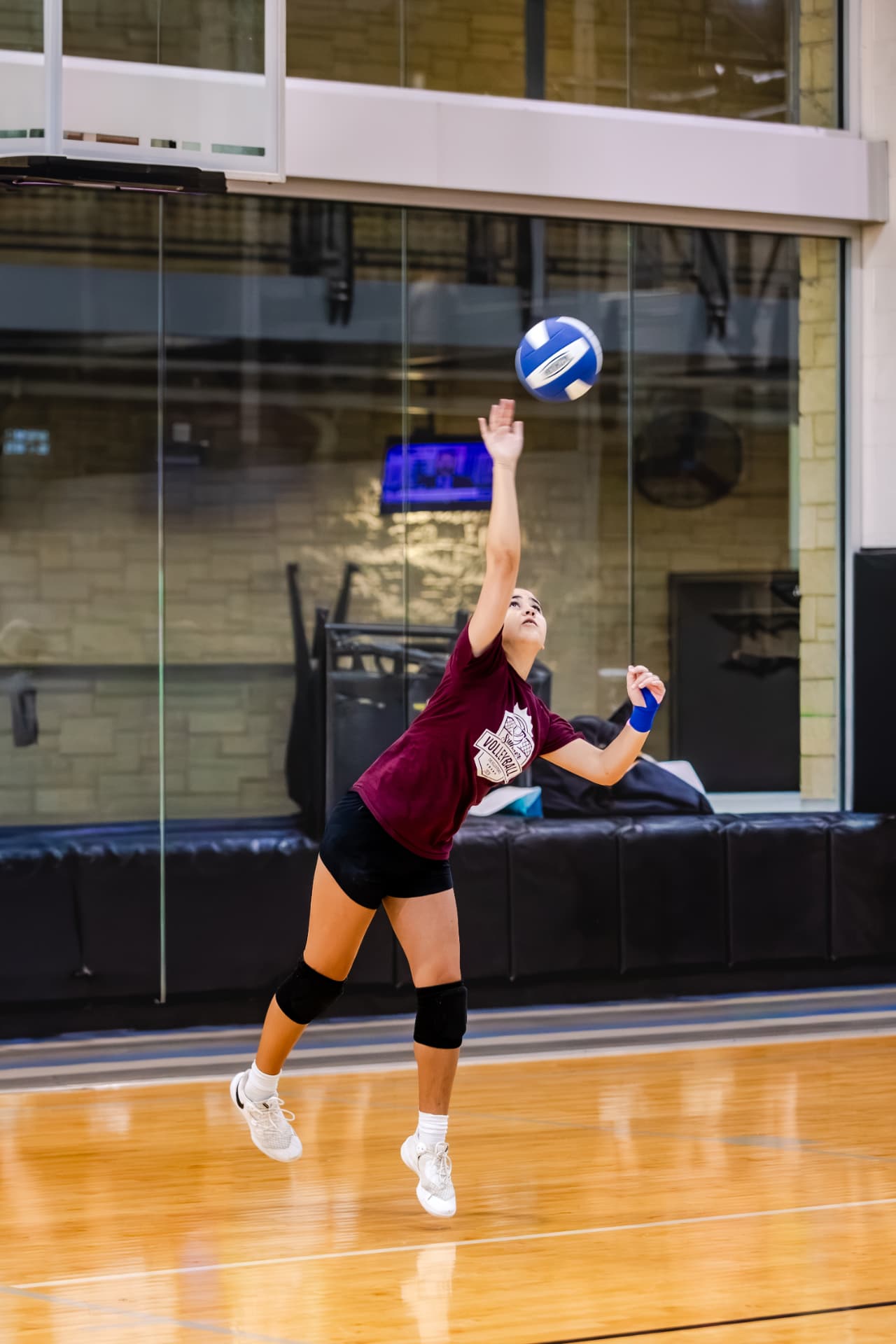 Volleyball player mid-air on a jump serve