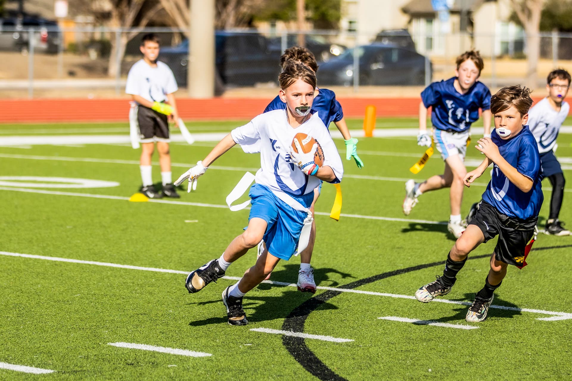 Youth flag football runner breaking away with the ball