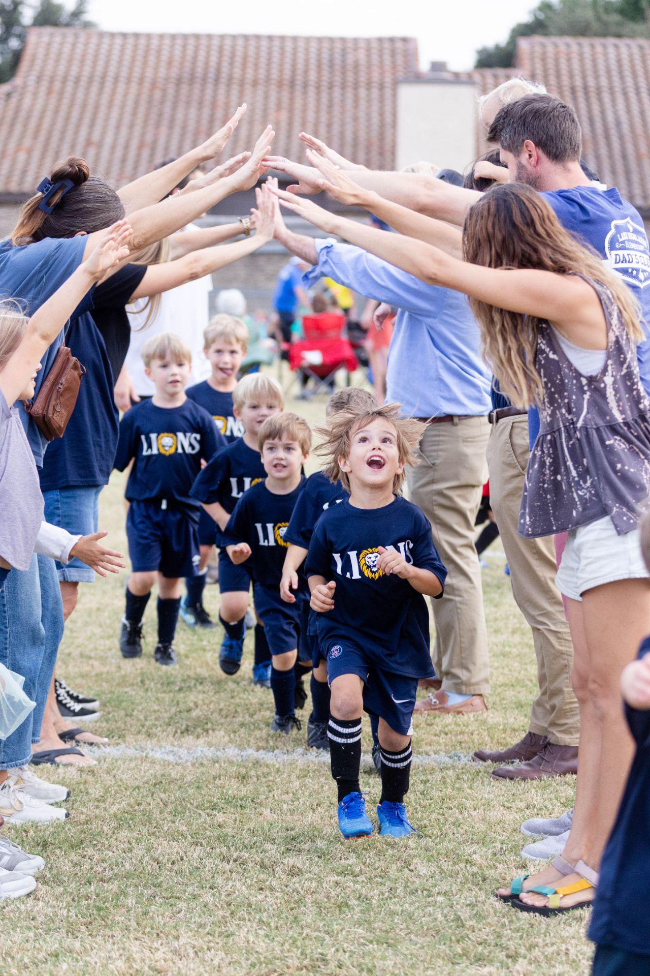 Youth football players walking onto the field